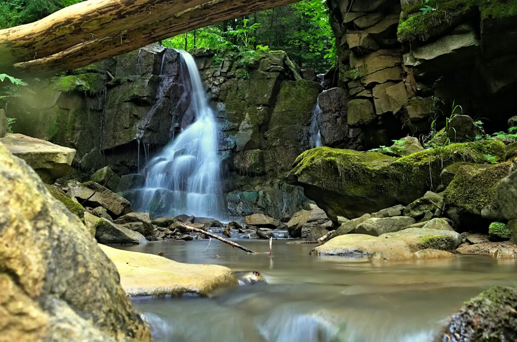 Scenic waterfall flowing over rocks in Slovak Paradise, offering a serene nature landscape.