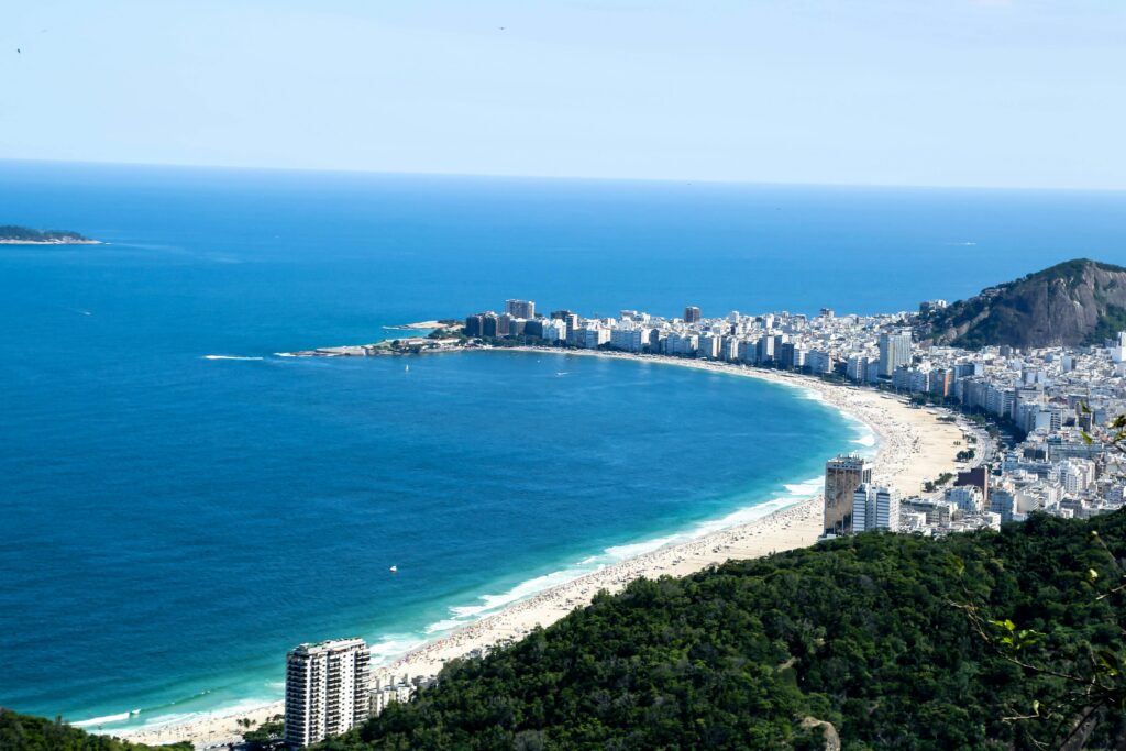 Stunning aerial view of Copacabana Beach and cityscape in Rio de Janeiro, Brazil, showcasing vibrant seaside life.