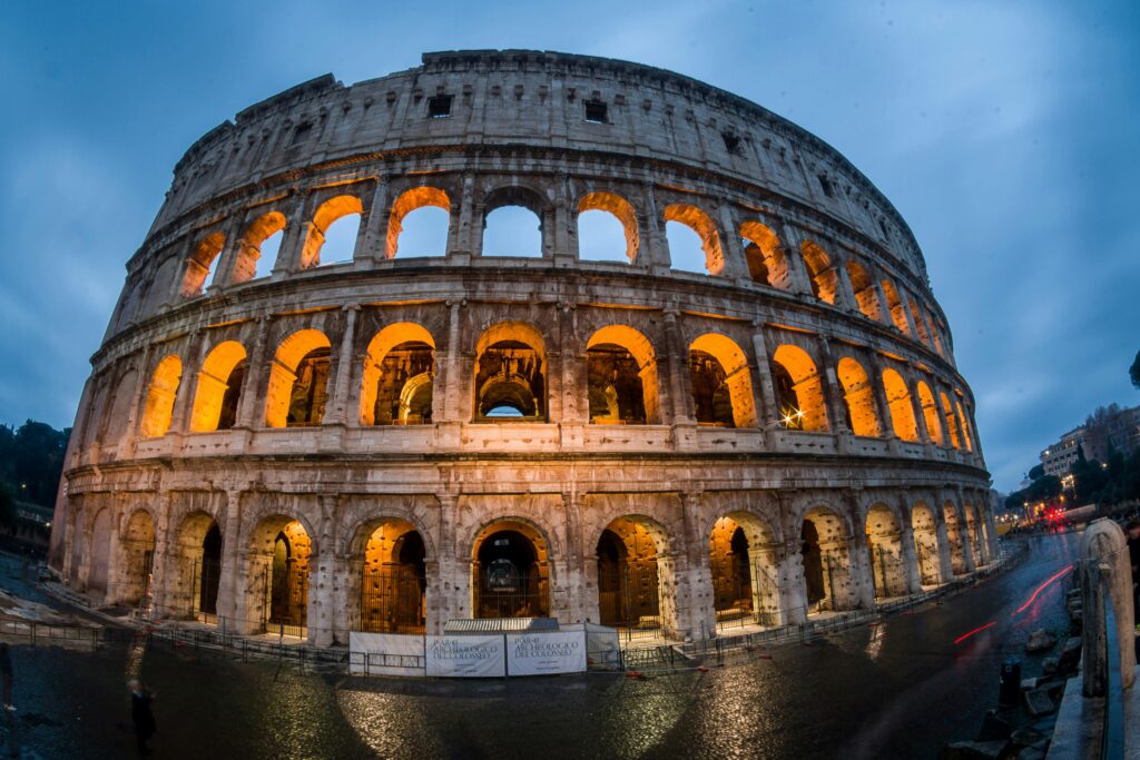 Stunning capture of the illuminated Colosseum in Rome during the evening, showcasing its historic grandeur.