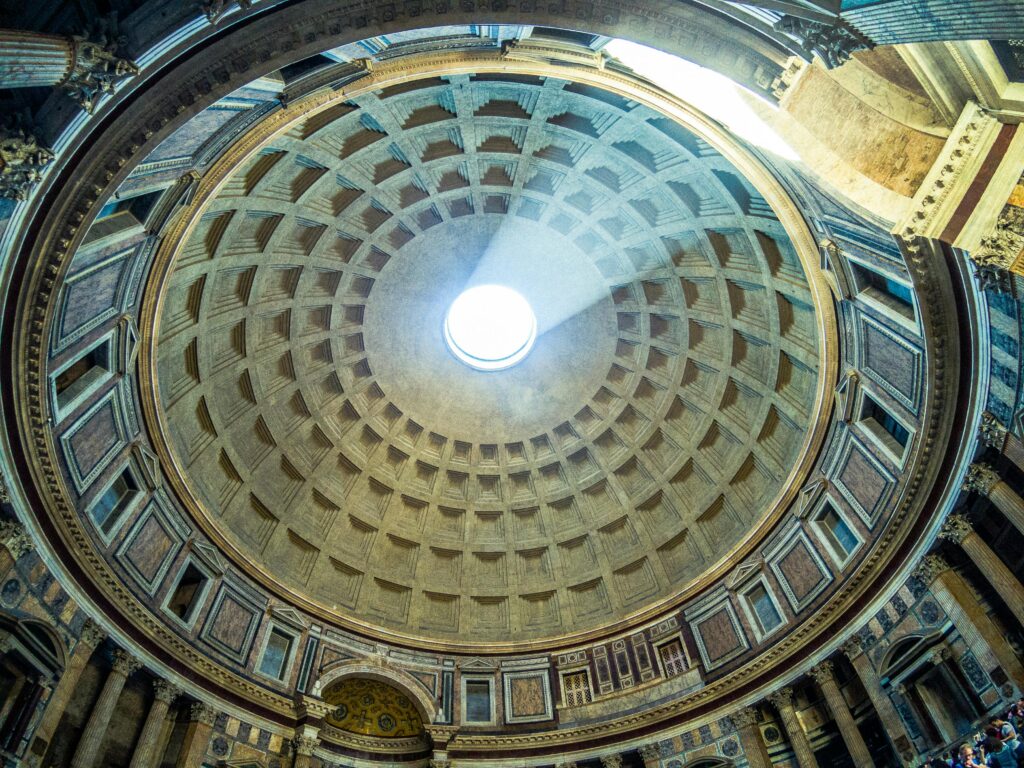 The beautiful architecture of an ancient dome with sunlight streaming through the oculus.
