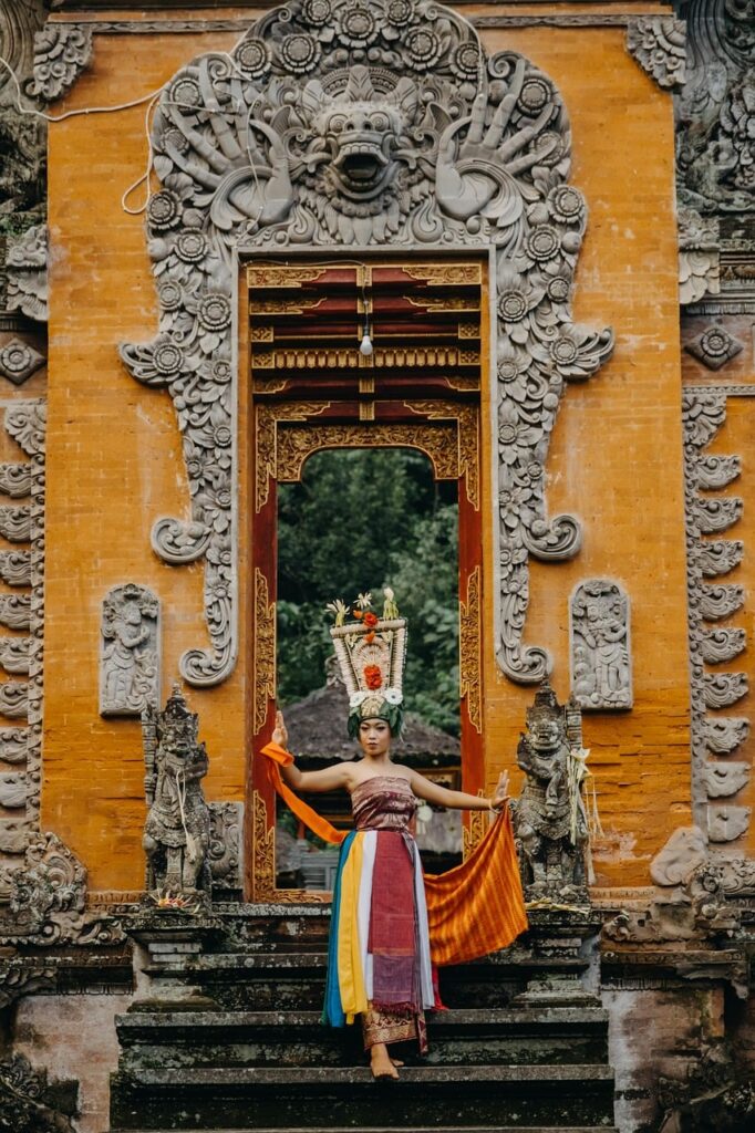 balinese temple, traditional attire, dancer, architecture, statues, history, decoration, cultural heritage, indonesia, colorful costume, performance, temples of bali, bali culture, traditional dance, staircase, decorative gate, mythical creature, artistic carvings, traditional ceremony