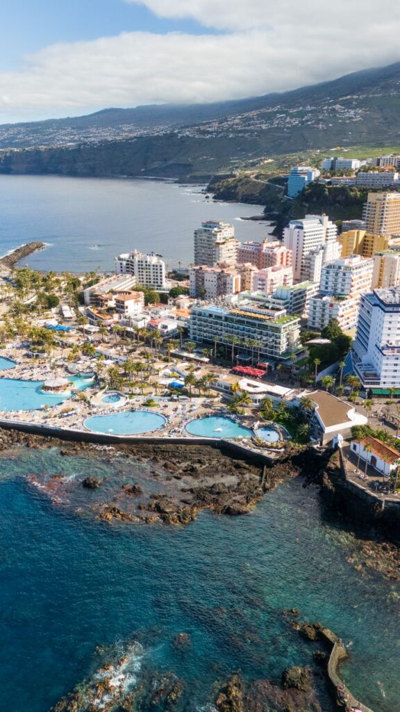 Stunning aerial view of Puerto de la Cruz with its coastline and modern architecture in Tenerife, Spain.