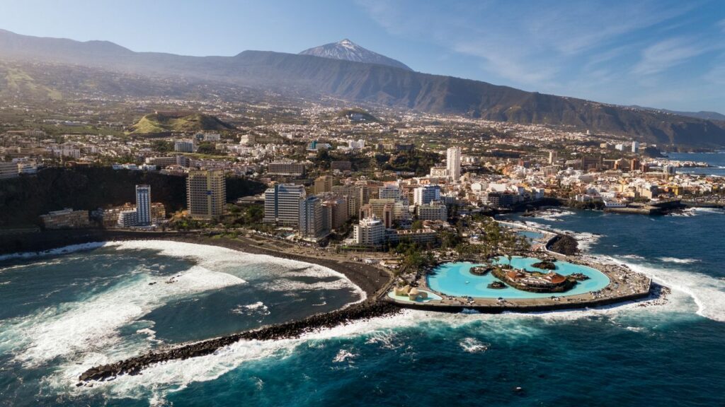 Stunning aerial view of Puerto de la Cruz with Mount Teide in the background.