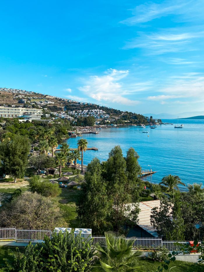Picturesque coastal landscape of Bodrum, Turkey, with clear blue waters and lush greenery.