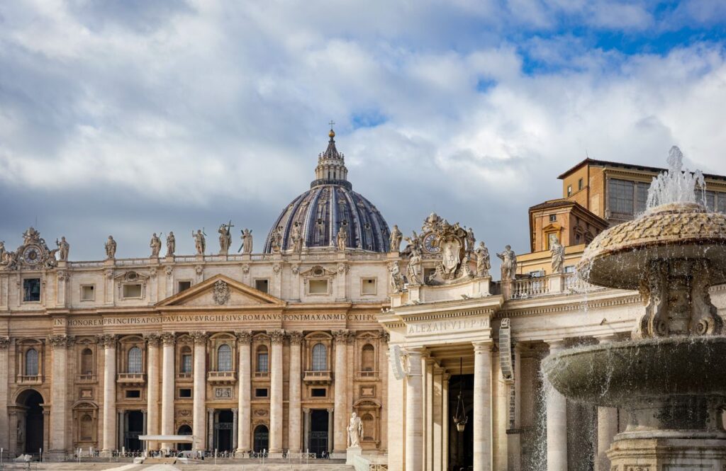 Explore St. Peter's Basilica in Vatican City with a clear blue sky backdrop.
