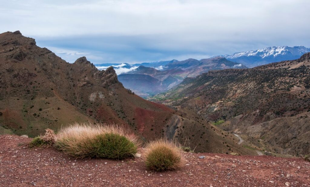 Scenic view of the Atlas Mountains in Morocco with rugged terrain and vast skies.
