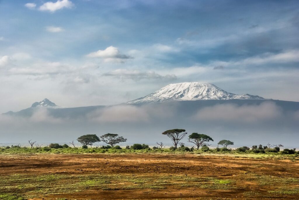 Breathtaking view of snow-capped Mount Kilimanjaro with surrounding African savannah.